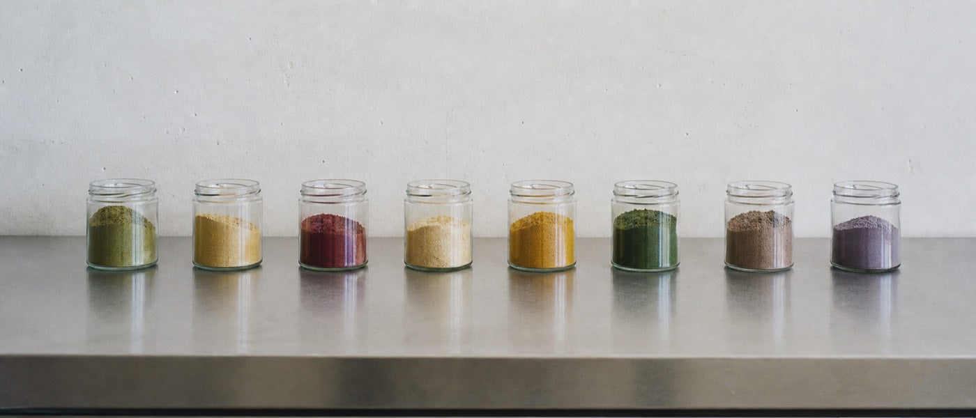 A steel bench of unlabelled sample jars